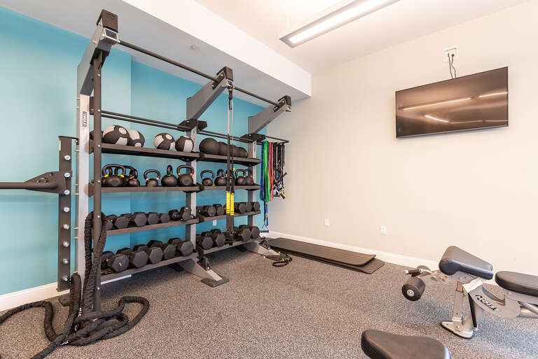 Fitness center at One Wall St in Attleboro with free weights.